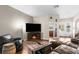 Inviting living room with hardwood floors, a fireplace, comfortable seating, and plenty of natural light at 12026 Penguin Ave, Weeki Wachee, FL 34614