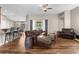 Open-concept living room with hardwood floors, stylish furniture, and views of the backyard at 12026 Penguin Ave, Weeki Wachee, FL 34614