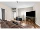 Cozy living room featuring a fireplace, hardwood floors, comfortable seating, and modern décor at 12026 Penguin Ave, Weeki Wachee, FL 34614