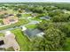 The aerial showcases the property's location with mature trees, a private backyard, and screened in patio at 12060 Sapphire Dr, Spring Hill, FL 34609