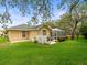 Well-maintained backyard with lush green lawn, patio area, and screened enclosure at 12060 Sapphire Dr, Spring Hill, FL 34609