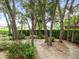 Backyard garden featuring a small bistro table and chairs surrounded by plants at 12060 Sapphire Dr, Spring Hill, FL 34609