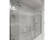 Bathroom featuring a glass-enclosed shower, neutral tile, and modern fixtures, providing a spa-like experience at 12060 Sapphire Dr, Spring Hill, FL 34609