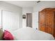 Bedroom featuring double closets and wooden armoire, providing ample storage space at 12060 Sapphire Dr, Spring Hill, FL 34609