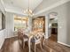 Spacious dining room with wood floors, a chandelier, and bright light offers lots of space for entertaining at 12060 Sapphire Dr, Spring Hill, FL 34609
