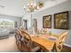 Well-lit dining room featuring wood floors and a chandelier, perfect for enjoying meals with Gathering and friends at 12060 Sapphire Dr, Spring Hill, FL 34609