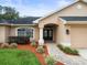 Inviting entrance with stone pathway, manicured landscaping, and double door entry at 12060 Sapphire Dr, Spring Hill, FL 34609