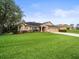 Well-maintained single-story home showcases a manicured lawn and tidy landscaping at 12060 Sapphire Dr, Spring Hill, FL 34609