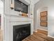Living room fireplace featuring a decorative mantel with a television and sconce lighting at 12060 Sapphire Dr, Spring Hill, FL 34609