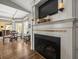 Cozy living room with a fireplace, TV, and adjacent dining area with large windows and lots of light at 12060 Sapphire Dr, Spring Hill, FL 34609