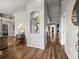 Long hallway featuring high ceilings, hardwood floors, elegant decor, and well-placed light fixtures at 12060 Sapphire Dr, Spring Hill, FL 34609