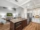 Open-concept kitchen featuring a center island, stainless appliances, and views of the living area at 12060 Sapphire Dr, Spring Hill, FL 34609