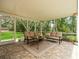 Enclosed lanai with brick flooring, comfortable seating, and views of a lush lawn at 12060 Sapphire Dr, Spring Hill, FL 34609