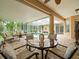 Spacious covered lanai with brick flooring, a seating area, and views of the pool at 12060 Sapphire Dr, Spring Hill, FL 34609