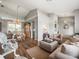 Open-concept living area with hardwood floors, lovely furnishings, and decorative light fixture at 12060 Sapphire Dr, Spring Hill, FL 34609
