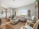 Bright and airy living room featuring hardwood floors, a large window, and comfortable seating at 12060 Sapphire Dr, Spring Hill, FL 34609