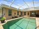 Relaxing screened-in pool area with lush landscaping and outdoor seating, ideal for entertaining at 12060 Sapphire Dr, Spring Hill, FL 34609