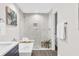 Bathroom featuring soaking tub and marble tiled shower with glass door at 12420 Talpa St, Spring Hill, FL 34608