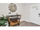 Charming entryway featuring a decorative wood cart, mirror, greenery, and a glass panel front door at 12420 Talpa St, Spring Hill, FL 34608