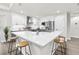 Bright kitchen featuring quartz countertops, stainless steel appliances, modern cabinets, and a spacious island with seating at 12420 Talpa St, Spring Hill, FL 34608