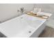 Close up of soaking tub featuring brushed nickel fixtures and bamboo tray at 12420 Talpa St, Spring Hill, FL 34608