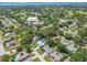 Stunning aerial view of a neighborhood with lush green landscaping, a lake, and community center at 1265 Royal Oak Dr, Dunedin, FL 34698