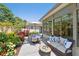 Charming outdoor seating area with dining and lounge spaces, surrounded by lush landscaping at 1265 Royal Oak Dr, Dunedin, FL 34698