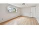 Simple bedroom with wood floors, window, and a closet at 1265 Royal Oak Dr, Dunedin, FL 34698