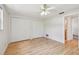 Bright bedroom with wood floors, white walls, ceiling fan, and double closets at 1265 Royal Oak Dr, Dunedin, FL 34698