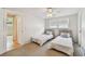 Cozy bedroom featuring twin beds, soft carpet, and a bright window view at 1265 Royal Oak Dr, Dunedin, FL 34698