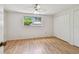 Bedroom with wood floor, window, and a closet at 1265 Royal Oak Dr, Dunedin, FL 34698