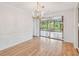 Elegant dining room featuring hardwood floors, decorative chandelier, and sliding doors to sunroom at 1265 Royal Oak Dr, Dunedin, FL 34698