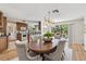 Dining room adjacent to kitchen and a lush backyard visible through sliding glass door at 1265 Royal Oak Dr, Dunedin, FL 34698