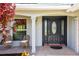Inviting front porch with decorative door, tiled floor, and comfortable seating area at 1265 Royal Oak Dr, Dunedin, FL 34698