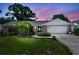Charming single-story home with brick accents, lush landscaping, and a well-maintained front yard at 1265 Royal Oak Dr, Dunedin, FL 34698
