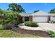 Charming single-story home with brick accents, lush landscaping, and a well-maintained front yard at 1265 Royal Oak Dr, Dunedin, FL 34698