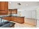 Traditional kitchen featuring wood cabinets, black countertops and tile floor at 1265 Royal Oak Dr, Dunedin, FL 34698