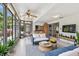 Inviting sunroom with tile flooring, stylish furnishings, and beautiful outdoor views at 1265 Royal Oak Dr, Dunedin, FL 34698