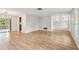 Bright and spacious living room featuring hardwood floors, neutral decor, and large windows at 1265 Royal Oak Dr, Dunedin, FL 34698