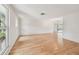Bright and spacious living room featuring hardwood floors, neutral decor, and large windows at 1265 Royal Oak Dr, Dunedin, FL 34698