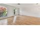 Bright and spacious living room featuring hardwood floors, neutral decor, and large windows at 1265 Royal Oak Dr, Dunedin, FL 34698