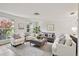 Bright living room featuring hardwood floors, neutral decor, and plenty of natural light at 1265 Royal Oak Dr, Dunedin, FL 34698