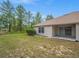 Backyard featuring a lawn and a covered patio with sliding glass doors at 13049 Moonstone Way, Spring Hill, FL 34609