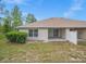 Backyard featuring a lawn and a covered patio with sliding glass doors at 13049 Moonstone Way, Spring Hill, FL 34609