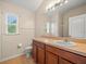 Bathroom featuring a vanity with sink, a toilet, and a mirror at 13049 Moonstone Way, Spring Hill, FL 34609