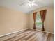Bright bedroom with vaulted ceiling, ceiling fan, and beautiful wood-look flooring at 13049 Moonstone Way, Spring Hill, FL 34609