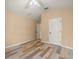 Bedroom featuring light walls, wood-look flooring, and a white door at 13049 Moonstone Way, Spring Hill, FL 34609