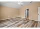 Bedroom featuring wood-look floors, ceiling fan, and neutral walls at 13049 Moonstone Way, Spring Hill, FL 34609