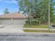 Charming single-story home with a three-car garage, tidy landscaping, and a well-maintained lawn at 13049 Moonstone Way, Spring Hill, FL 34609