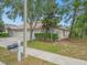 Charming single-story home with a three-car garage, tidy landscaping, and a well-maintained lawn at 13049 Moonstone Way, Spring Hill, FL 34609